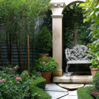 home backyard garden well designed with pathway bench trellis